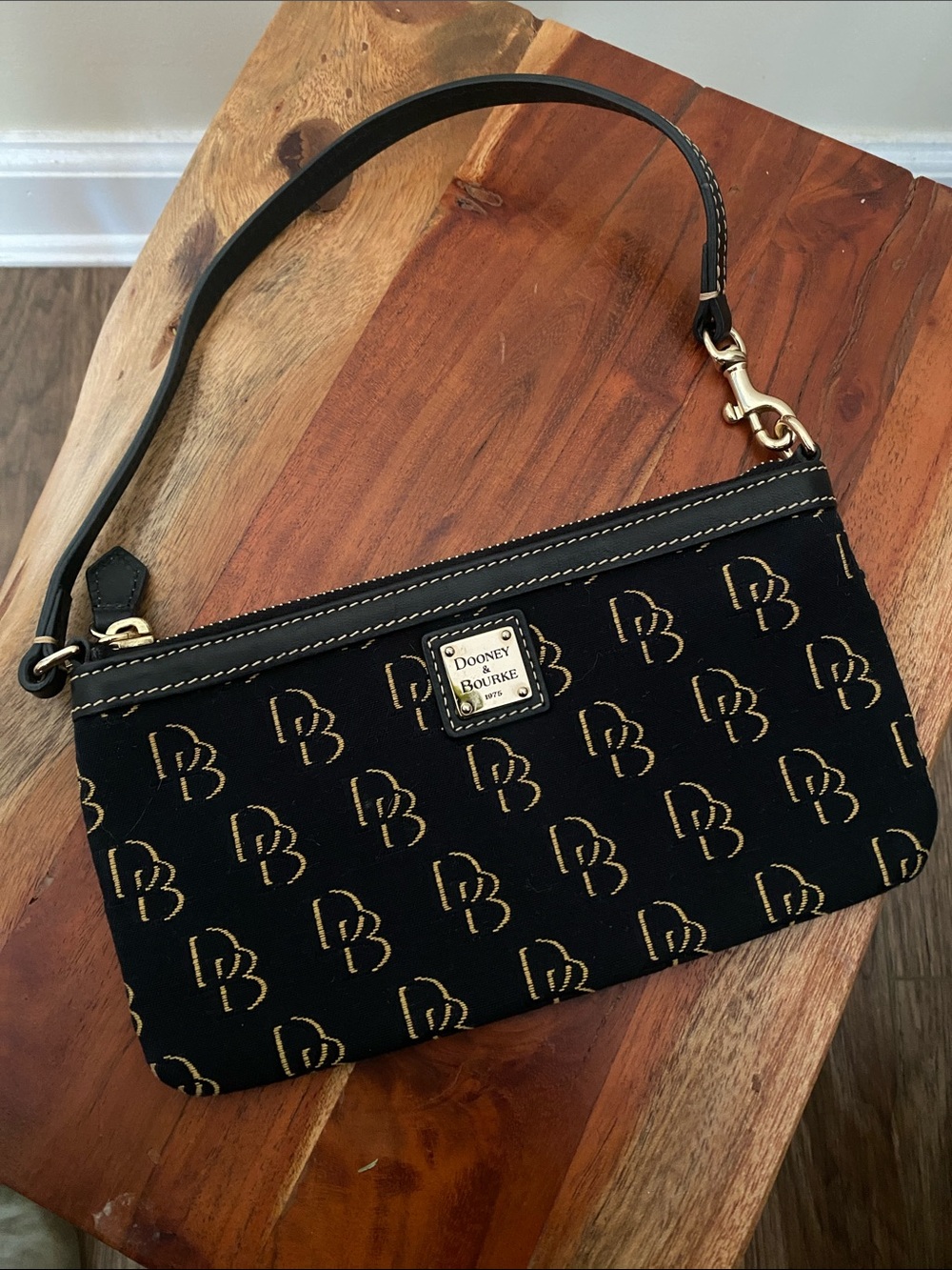 Dooney & Bourke Black and Gold Signature Wristlet sling bag monogrammed